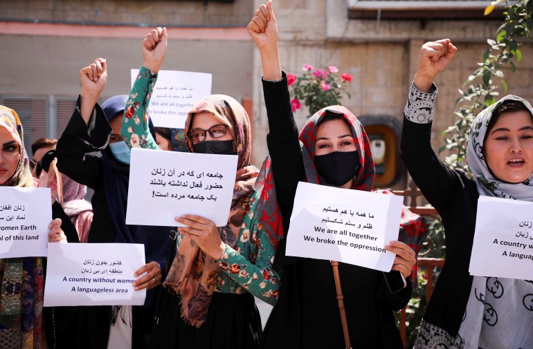 Afghan women's rights defenders and civil activists protest to call on the Taliban for the preservation of their achievements and education, in front of the presidential palace in Kabul