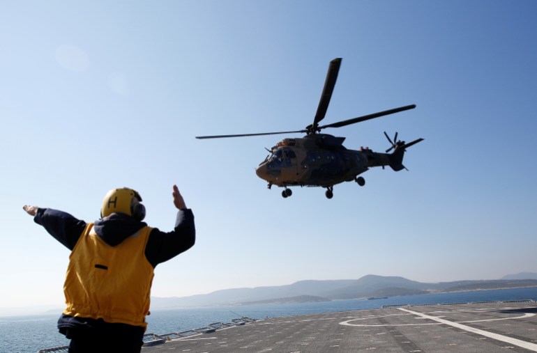 A military helicopter takes off from the TCG Bayraktar (L-402) to take part in a landing drill during the Blue Homeland naval exercise off the Aegean coastal town of Foca in Izmir Bay