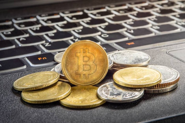 bitcoin and laptop - stock photo