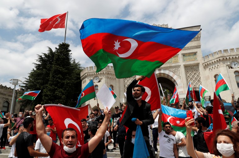 Azeri men living in Turkey wave flags of Turkey and Azerbaijan during a protest following clashes between Azerbaijan and Armenia, in Istanbul, Turkey, July 19, 2020. REUTERS/Murad Sezer