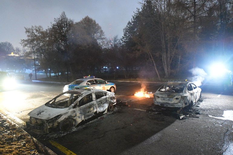 Damaged cars are seen near the mayor's office in Almaty