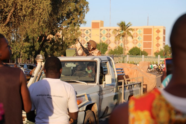 An army soldier rides a truck after the deposition of President Kabore, in Ouagadougou