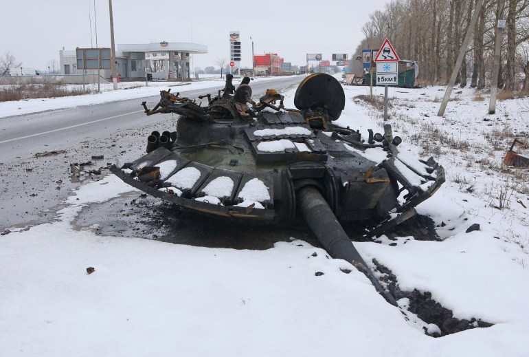 The turret of a destroyed tank is seen on the roadside in Kharkiv