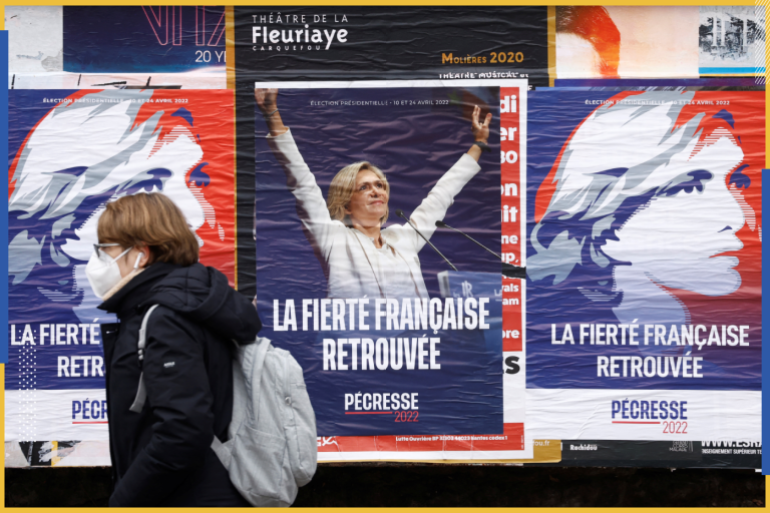 A woman walks past campaign posters of Valerie Pecresse, head of the Paris Ile-de-France region and Les Republicains (LR) right-wing party candidate for the 2022 French presidential election, in Nantes, France, January 24, 2022. REUTERS/Stephane Mahe