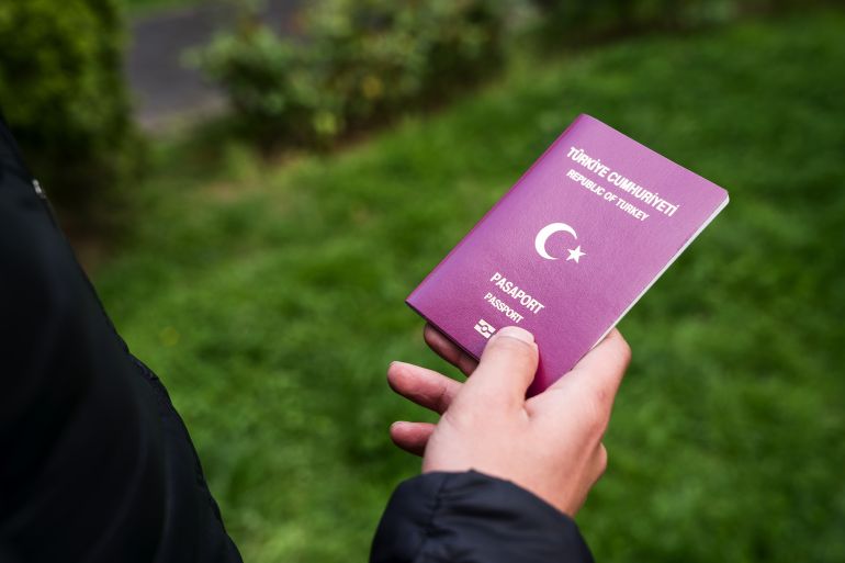 Man,Holding,Turkish,Passport
