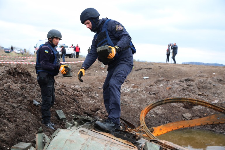 Members of a demining team of the State Emergency Service of Ukraine clear mines off a field near the town of Brovary, northeast of Kyiv, on April 21, 2022, amid Russian invasion of Ukraine. (Photo by Aleksey Filippov / AFP)
