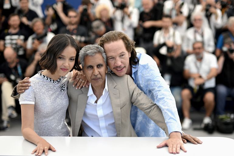 (From L) Algerian-French actress Lyna Khoudri, director Rachid Bouchareb and French actor Reda Kateb pose during a photocall for the film "Nos Frangins (Our Brothers)" at the 75th edition of the Cannes Film Festival in Cannes, southern France, on May 24, 2022. (Photo by LOIC VENANCE / AFP)