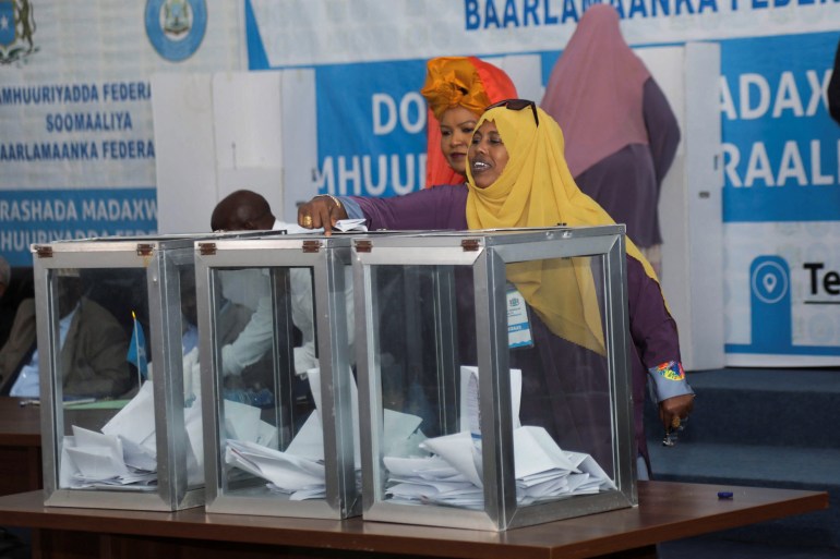 A member of the Somali parliament casts a ballot during the first round of the Somali presidential elections, in Mogadishu