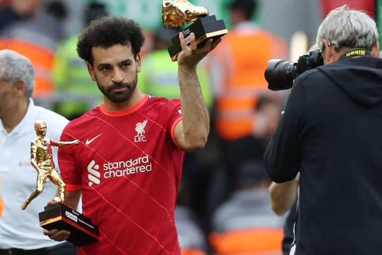 Premier League - Liverpool v Wolverhampton Wanderers Soccer Football - Premier League - Liverpool v Wolverhampton Wanderers - Anfield, Liverpool, Britain - May 22, 2022 Liverpool's Mohamed Salah holding the Premier League Playmaker and Golden Boot winner trophies after the match REUTERS/Phil Noble EDITORIAL USE ONLY. No use with unauthorized audio, video, data, fixture lists, club/league logos or 'live' services. Online in-match use limited to 75 images, no video emulation. No use in betting, games or single club /league/player publications. Please contact your account representative for further details