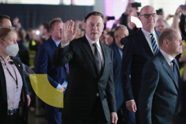 GRUENHEIDE, GERMANY - MARCH 22: German Chancellor Olaf Scholz (R), Brandenburg State Premier Dietmar Woidke (2ndR) and Tesla CEO Elon Musk (C) attend the official opening of the new Tesla electric car manufacturing plant on March 22, 2022 near Gruenheide, Germany. The new plant, officially called the Gigafactory Berlin-Brandenburg, is producing the Model Y as well as electric car batteries. (Photo by Christian Marquardt - Pool/Getty Images)