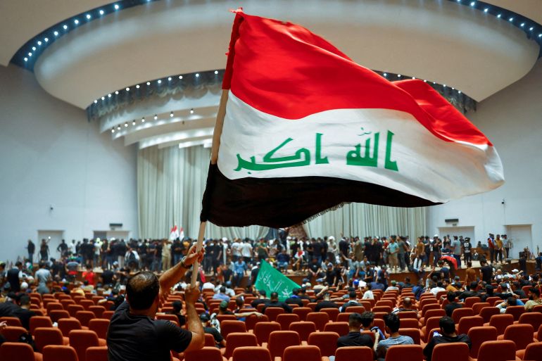 FILE PHOTO: Supporters of Iraqi Shi'ite cleric Moqtada al-Sadr protest against corruption, inside the parliament in Baghdad, Iraq July 30, 2022. To match Special Report IRAQ-IRAN/SHIITES REUTERS/Thaier Al-Sudani/File Photo