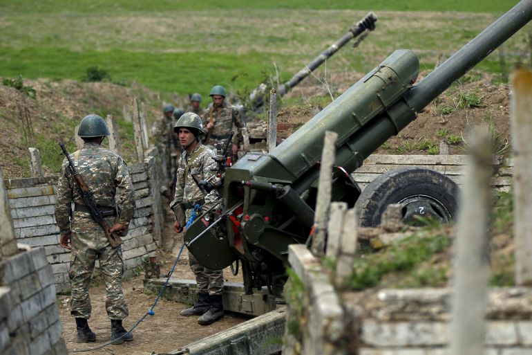 Ethnic Armenian soldiers stand next to a cannon at artillery positions near the Nagorno-Karabakh's town of Martuni, April 7, 2016. REUTERS/Staff TPX IMAGES OF THE DAY
