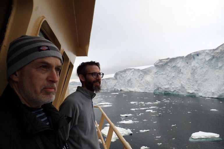 THOR scientists Alastair Graham (right) and Robert Larter (left) look on in awe at the crumbling ice face of the Thwaites Glacier margin, from the bridge deck of the R/V Nathaniel B. Palmer. (Credit: Frank Nitsche).