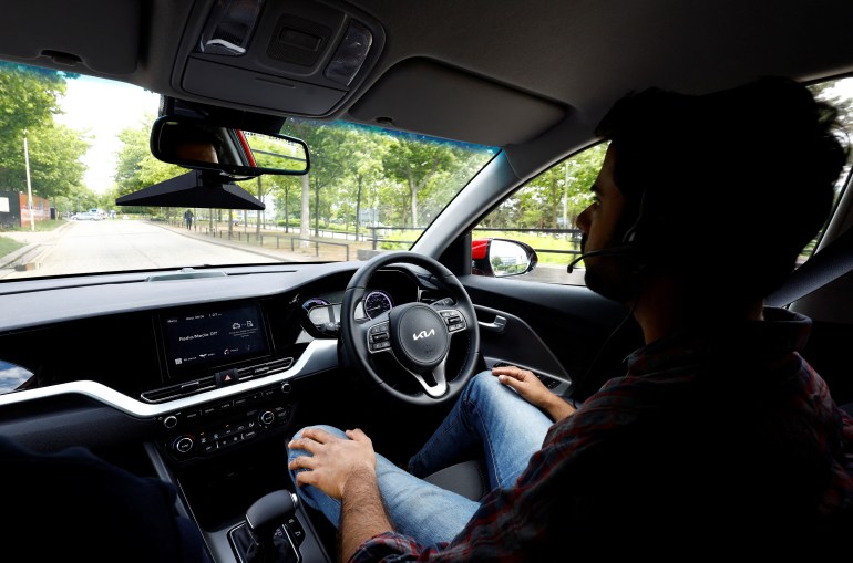 A Fetch driverless car is driven on the road by an operator in Imperium Drive’s office while ‘a safety driver' sits in the drivers seat, during driverless car trials in Milton Keynes, Britain, June 8, 2022. REUTERS/Andrew Boyers