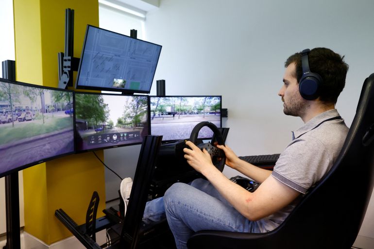 An operator controls a Fetch driverless car from the office of Imperium Drive, during driverless car trials, in Milton Keynes, Britain, June 8, 2022. REUTERS/Andrew Boyers