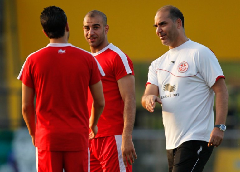 Tunisia head coach Trabelsi talks to his players during a training session in Bongoville