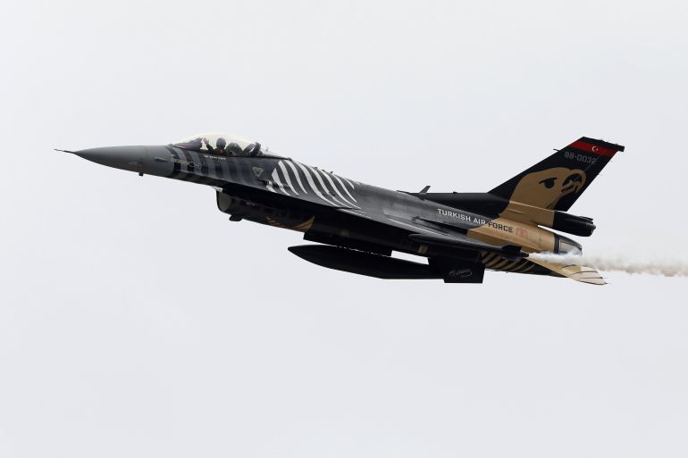 Turkish Air Force pilot gestures as he flies F-16C during the Pakistan Day military parade in Islamabad