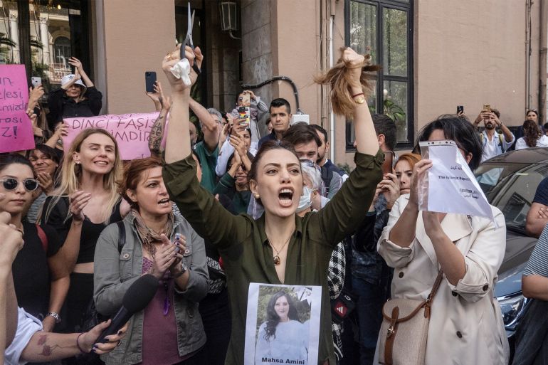 epa10196678 An Iranian woman reacts after cutting her hair during a protest outside the Iranian Consulate following the death of Mahsa Amini, in Istanbul, Turkey, 21 September 2022. Mahsa Amini, a 22-year-old Iranian woman, was arrested in Tehran on 13 September by the morality police, a unit responsible for enforcing Iran's strict dress code for women. She fell into a coma while in police custody and was declared dead on 16 September. EPA-EFE/ERDEM SAHIN