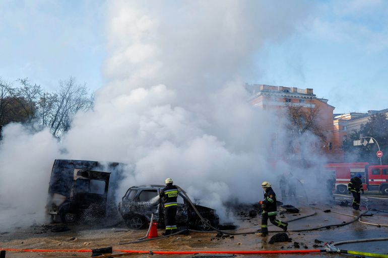 Firefighters work to put out fire at the scene of a missile attack in Kyiv. [Valentyn Ogirenko/Reuters]