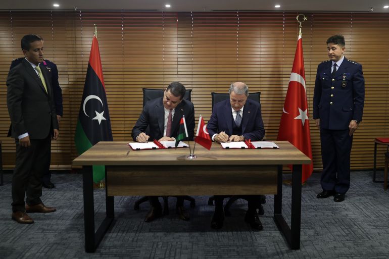 ISTANBUL, TURKIYE - OCTOBER 25: Turkish Minister of National Defense Hulusi Akar (C- R) and Libya's Prime Minister of National Unity Government Abdul Hamid Dbeibeh (C - L) sign agreement between two countries after their meeting in Istanbul, Turkiye on October 25, 2022. Turkish Armed Forces to contribute to the training of Libyan military pilots. ( Arif Akdoğan - Anadolu Agency )