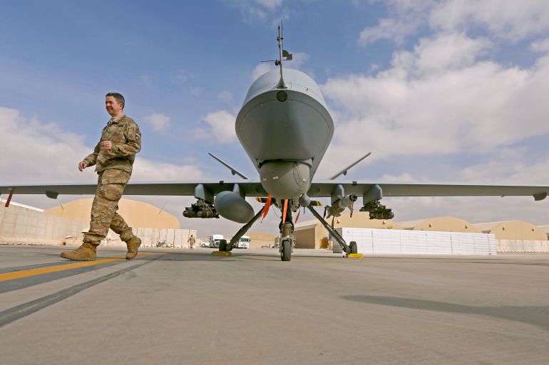 U.S. service member passes in front of a MQ-9 Reaper drone, one of a squadron that has arrived to step up the fight against the Taliban, at the Kandahar air base, Afghanistan January 23, 2018. REUTERS/Omar Sobhani