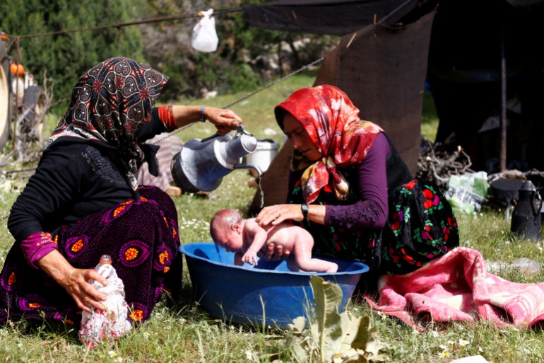 Rukiye Gobut washes her 20 day-old baby Efe Gobut near Konya, Turkey, May 22, 2018. Every year, nomads start walking from Mersin on the Mediterranean coast with more than a thousand goats, travelling to the central Anatolian province of Konya. REUTERS/Osman Orsal SEARCH "ORSAL NOMADS" FOR THIS STORY. SEARCH "WIDER IMAGE" FOR ALL STORIES. TPX IMAGES OF THE DAY.