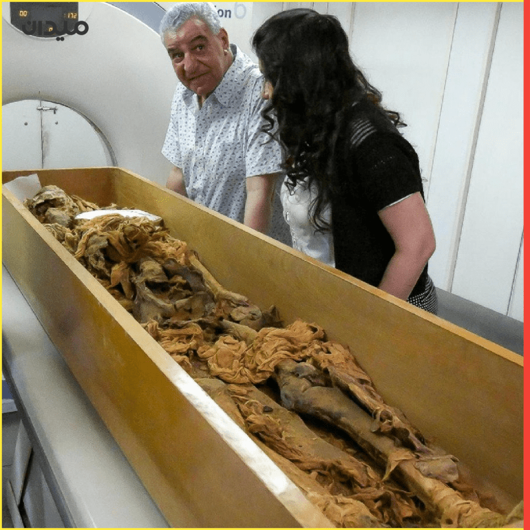 Zahi Hawass, an Egyptologist, stands next to assistant as a mummy, said to be belonging to an ancient Egyptian King, is put through a CT scanner (computerized Tomography) in Egypt, in this handout photo received on February 17, 2021. The Egyptian Ministry of Antiquities/Handout via REUTERS ATTENTION EDITORS - THIS IMAGE WAS PROVIDED BY A THIRD PARTY
