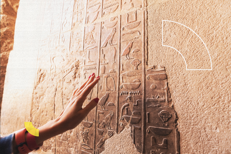 An Egyptologist or archaeologist reads and translates Egyptian hieroglyphs carved in stone