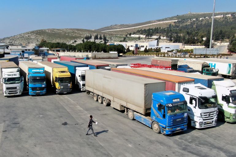 Trucks carrying aid from UN World Food Programme (WFP) are parked at Bab al-Hawa crossing