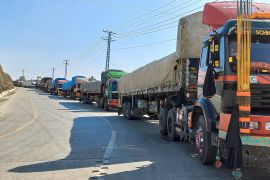 Trucks loaded with supplies to leave for Afghanistan, seen stranded after Taliban authorities have closed the main border crossing in Torkham
