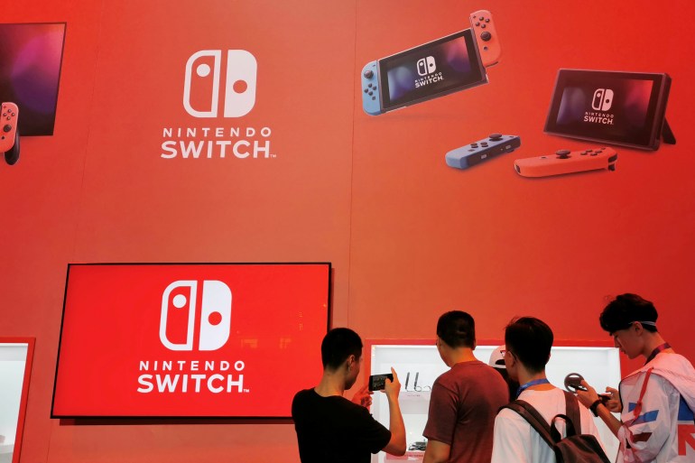 Visitors are seen at a booth of Nintendo Switch at the China Digital Entertainment Expo and Conference, also known as ChinaJoy, in Shanghai