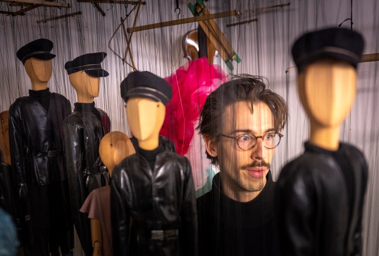 Puppeteer Edouard Funck is seen with faceless puppets in a storage prior to the Snow White fairytale puppet show at the UNESCO recognized Salzburg Marionette Theatre in Salzburg, Austria, on February 14, 2023. - It takes as long to train to be a puppeteer at the world-famous Salzburg Marionette Theatre as it does to become a doctor. The puppets and their startlingly lifelike movements take years to master, which is why the Austrian theatre's work has UNESCO World Heritage status. (Photo by JOE KLAMAR / AFP)