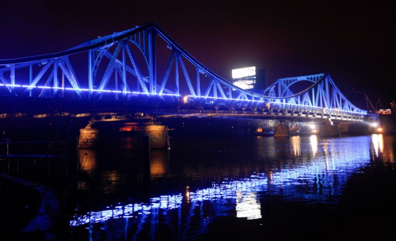 The Glienicker Bridge is illuminated before a ceremony in Berlin