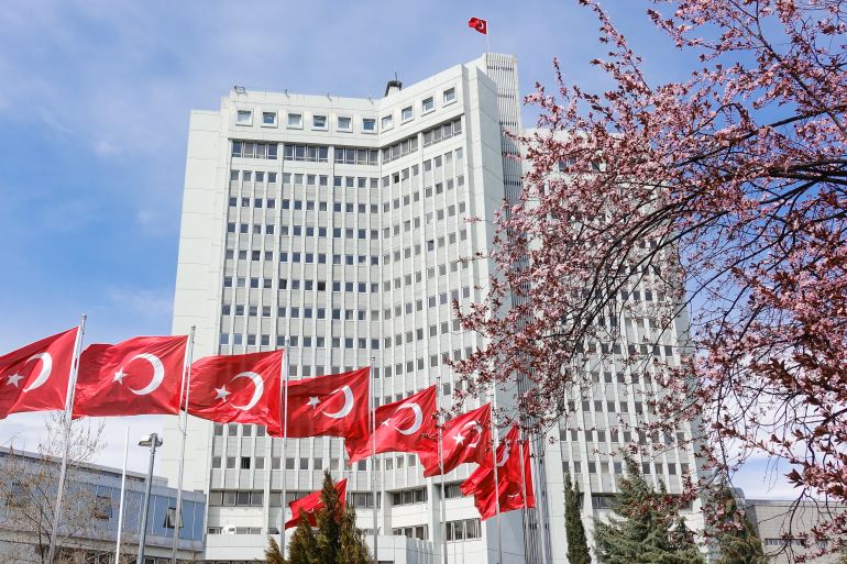 Ankara / Turkey - MARCH 29 2019: Ministry of Foreign Affairs building with cherry blossoms and National flag flapping in Ankara, Turkey 1364439431
