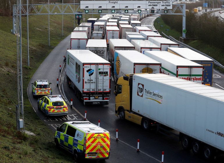 Freight vehicles line up prior to boarding a train to France via the Channel Tunnel, amid the coronavirus disease (COVID-19) outbreak, in Folkestone, Britain, December 20, 2020. REUTERS/Peter Nicholls