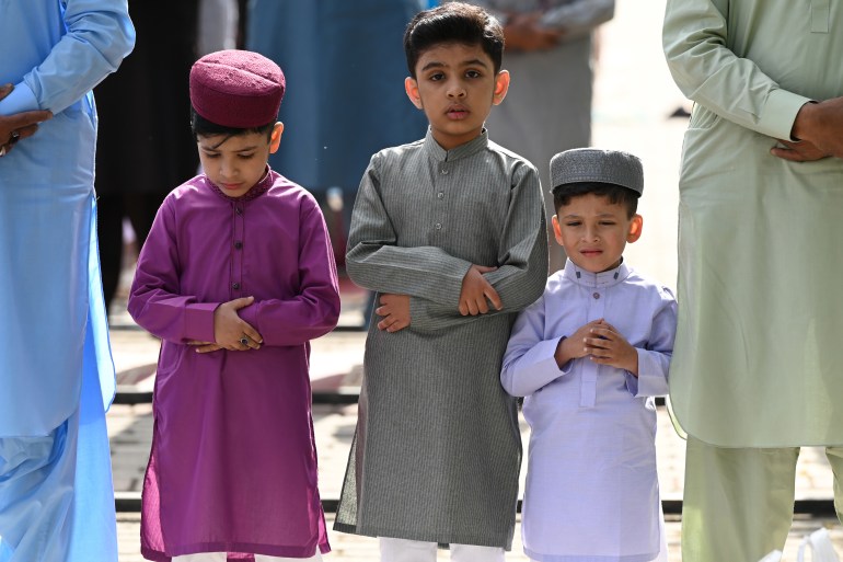 Muslim children attend the Eid al-Fitr prayer, which mark the end of their holy fasting month of Ramadan, in Rawalpindi on April 22, 2023. (Photo by Farooq NAEEM / AFP)