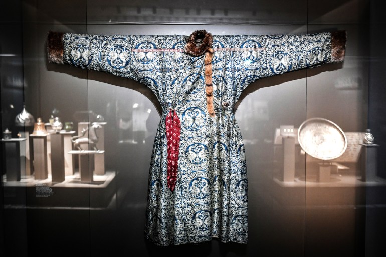 NOVEMBER 15, 2021 - 11:30 AM france  -  culture  -  exhibition  -  al thani Paris, France STEPHANE DE SAKUTINAFP This photograph taken on November 15, 2021, shows a robe from Iran or Central Asia (Seljuk, 1020-1160) displayed at the National Museum la Marine in Paris, during the opening of the exhibition "Trésors de la Collection Al Thani". The Al Thani Collection’s inaugural exhibition at the Hotel de la Marine will showcase a rich diversity of artworks representing numerous civilisations and spanning more than 5,000 years. (Photo by STEPHANE DE SAKUTIN / AFP) / RESTRICTED TO EDITORIAL USE - MANDATORY MENTION OF THE ARTIST UPON PUBLICATION - TO ILLUSTRATE THE EVENT AS SPECIFIED IN THE CAPTION - RESTRICTED TO EDITORIAL USE - MANDATORY MENTION OF THE ARTIST UPON PUBLICATION - TO ILLUSTRATE THE EVENT AS SPECIFIED IN THE CAPTION