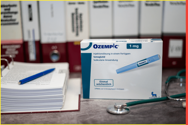 03.06.2022 Germany A Drug box of Ozempic containing Semaglutide for treatment of type 2 diabetes and long-term weight management on a table and in the background different medical books.