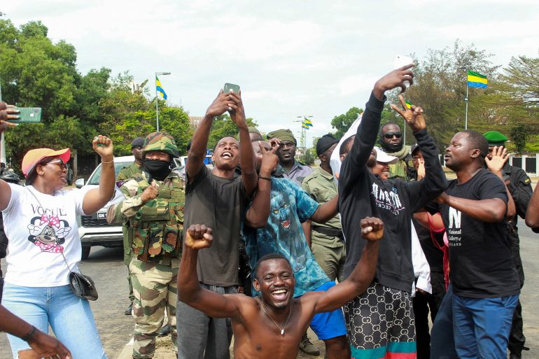 People pose with soldiers as they celebrate in support of the putschists in a street of Libreville, Gabon August 30, 2023 REUTERS/Scott Ngokila NO RESALES. NO ARCHIVES