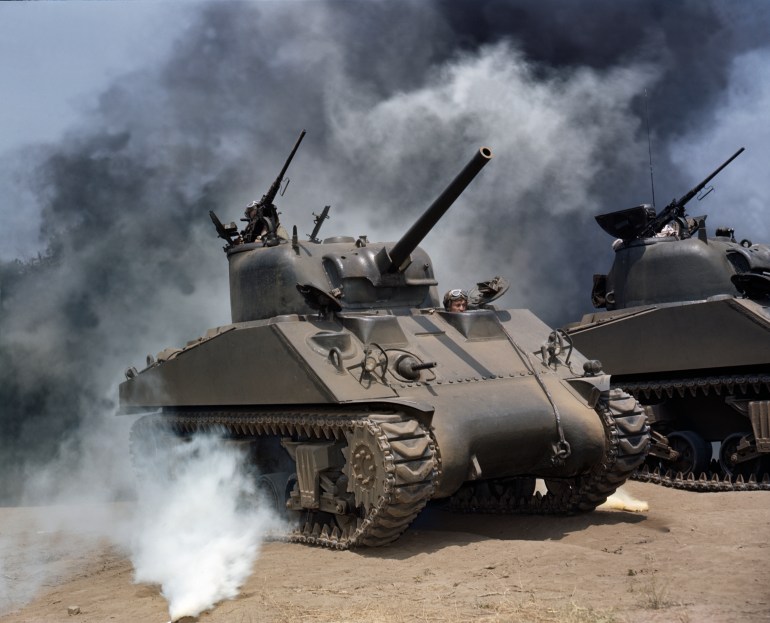 View of a pair of M4 Sherman tanks as they manouver through smoke during a training exercise, July 1942. (Photo by Camerique/Getty Images)