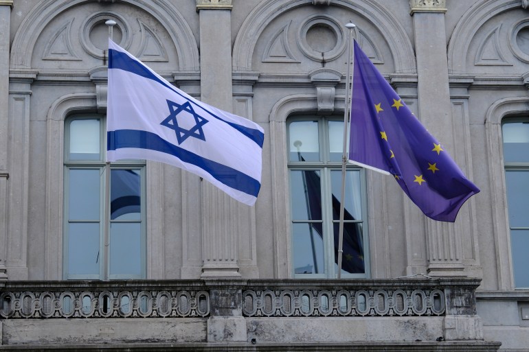 The flag of Israel and EU hang in front of the European Parliament in Brussels, Belgium on October 9, 2023.