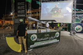 Members of the Al-Qassam Brigades, the military wing of the Islamist movement Hamas, stand next to a drone during a rally in Khan Yunis in the southern Gaza Strip, on July 26, 2022.