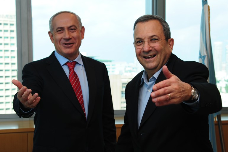 TEL AVIV, ISRAEL - NOVEMBER 26 : (ISRAEL OUT) In this handout image provided by the Israeli Government Press Office (GPO), Prime Minister Benjamin Netanyahu (L) and Defence Minister Ehud Barak gesture and smile as Brig. Gen. Eyal Zamir (not pictured) is appointed the new military secretary, on November 26, 2012 in Tel Aviv, Israel. The appointment comes following eight days of conflict with Hamas. (Photo by Kobi Gideon/GPO via Getty Images)