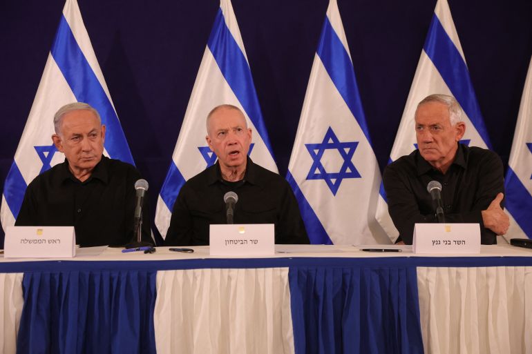 Israeli Prime Minister Benjamin Netanyahu (L), Defence Minister Yoav Gallant (C) and Cabinet Minister Benny Gantz hold a press conference in the Kirya military base in Tel Aviv on October 28, 2023 amid ongoing battles between Israel and the Palestinian group Hamas. - Netanyahu said on October 28 that fighting inside the Gaza Strip would be "long and difficult", as Israeli ground forces operate in the Palestinian territory for more than 24 hours. (Photo by Abir SULTAN / POOL / AFP)