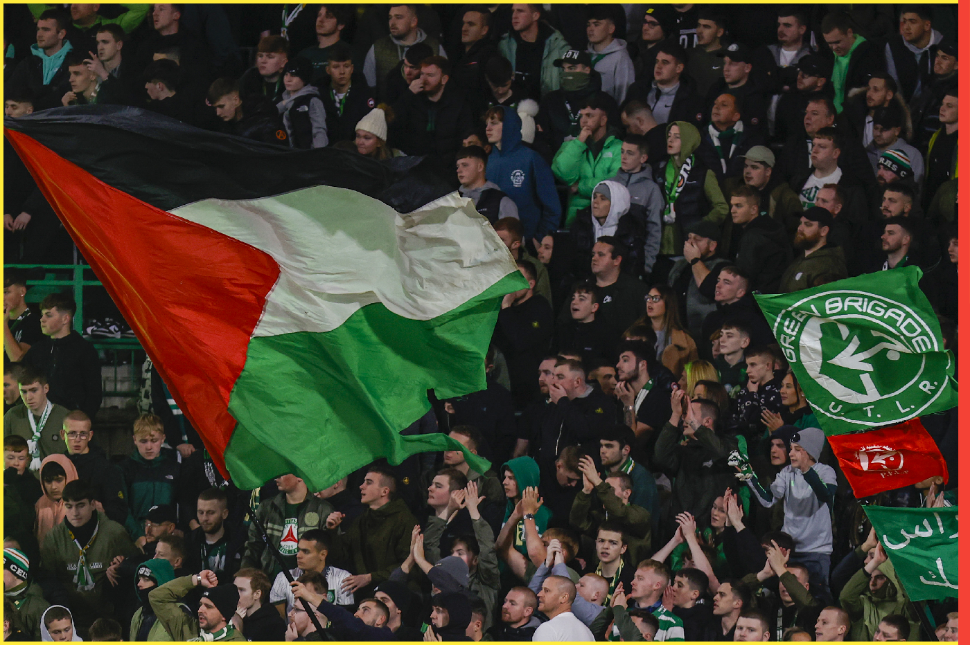 Supporters hold Palestinian flags during Celtic FC v Atletico Madrid - - GLASGOW, SCOTLAND - OCTOBER 25: Supporters hold Palestinian flags as they cheer prior to the start of the UEFA Champions League group E football match between Celtic and Atletico Madrid at Celtic Park stadium in Glasgow, Scotland on October 25, 2023.