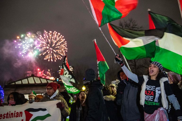 New Year's Eve fireworks go off in the sky as Pro-Palestinian demonstrators protest in Boston, Massachusetts on December 31, 2023. - Israeli strikes pounded Gaza on December 31 as both sides near the end of a dark year and Prime Minister Benjamin Netanyahu warned the war sparked by Hamas's October 7 attack will last for "many months". (Photo by Joseph Prezioso / AFP)