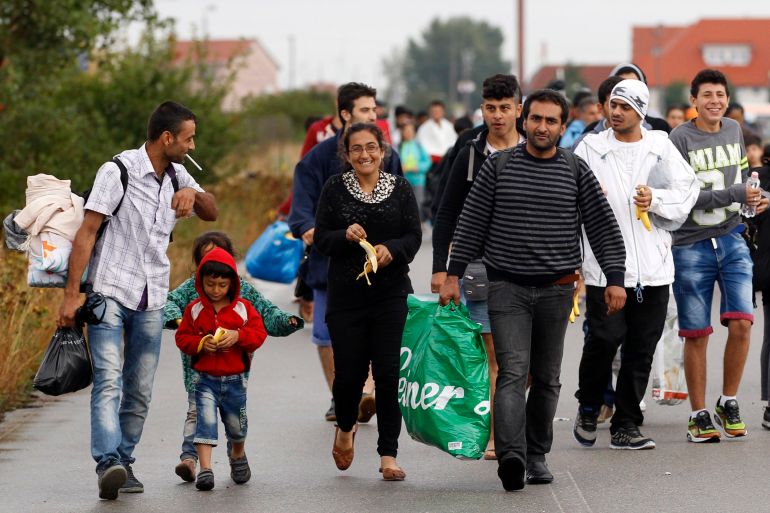 Migrants walk near the Hungarian-Austrian border in Nickelsdorf, Austria, Saturday, Sept. 5, 2015, where they arrived from Budapest as Austria in the early-morning hours said it and Germany would let them in. (AP Photo/Petr David Josek)