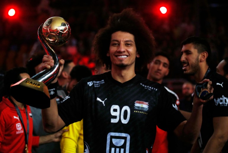 Handball - African Championship - Final - Egypt v Algeria - Cairo Stadium Indoor Hall, Cairo, Egypt - January 27, 2024 Egypt's Ali Zein celebrates with the trophy after winning the African Championship and qualifying for the Paris Olympics REUTERS/Amr Abdallah Dalsh