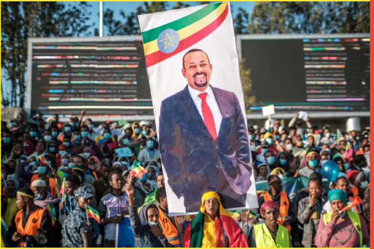 A woman holds a banner with the portrait of Primer Minister Abiy Ahmed during a rally in Addis Ababa, Ethiopia, on November 7, 2021, in support of the national defense forces. - Five days after the government declared a state of emergency throughout the country, tens of thousands of Ethiopians vowed at a pro-government rally in Addis Ababa on November 7 to defend the capital against Tigrayan rebels and denounced diplomatic efforts to end the conflict in the north of the country. (Photo by EDUARDO SOTERAS / AFP) (AFP)