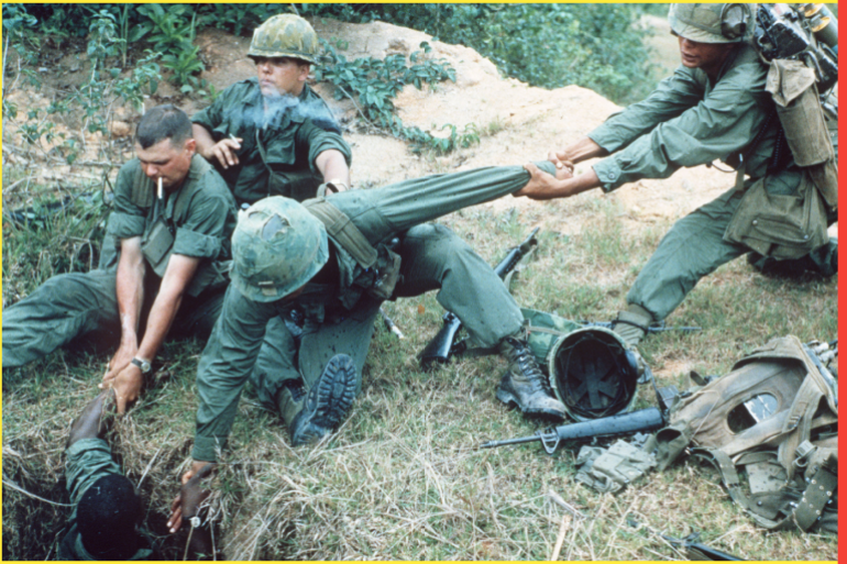 Troops being lowered into tunnel during Operation Oregon search and destroy mission by United States 1st Reconnaissance squadron west of Duc Pho, Quang Ngai province during the war in Vietnam